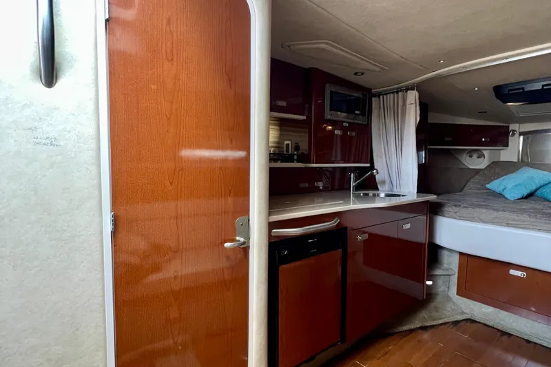 Slide: The Image of Interior of 2010 Sea Ray 350 Sundancer with kitchenette and cozy sleeping area. - 57