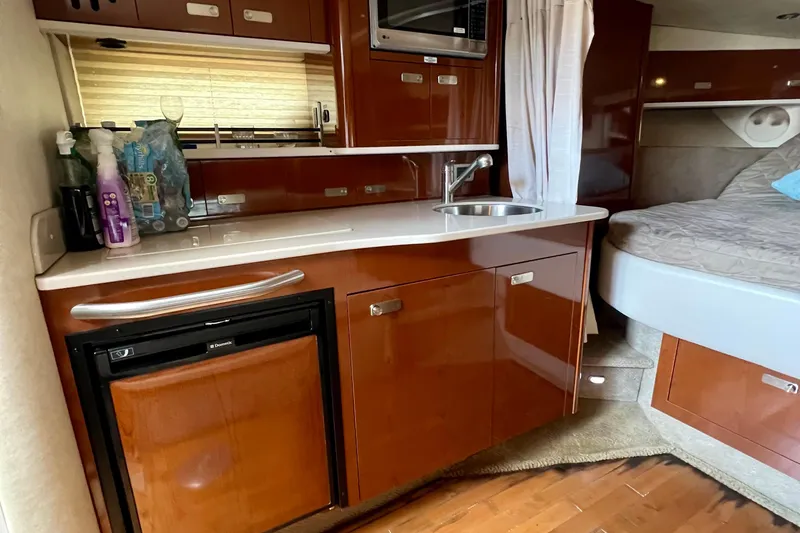 Slide: The Image of Interior of 2010 Sea Ray 350 Sundancer with kitchenette and bed. - 58