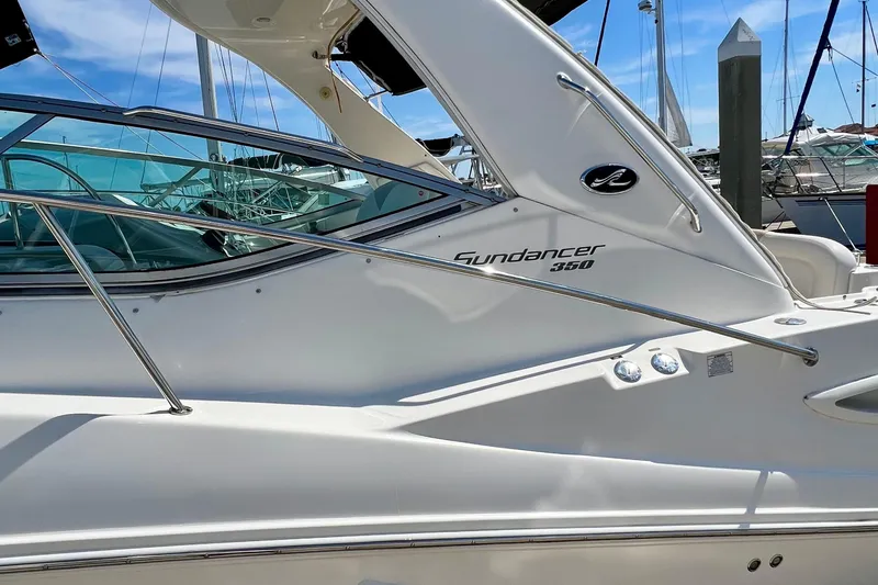 Slide: The Image of 2010 Sea Ray 350 Sundancer yacht docked, showcasing sleek design and branding. - 7