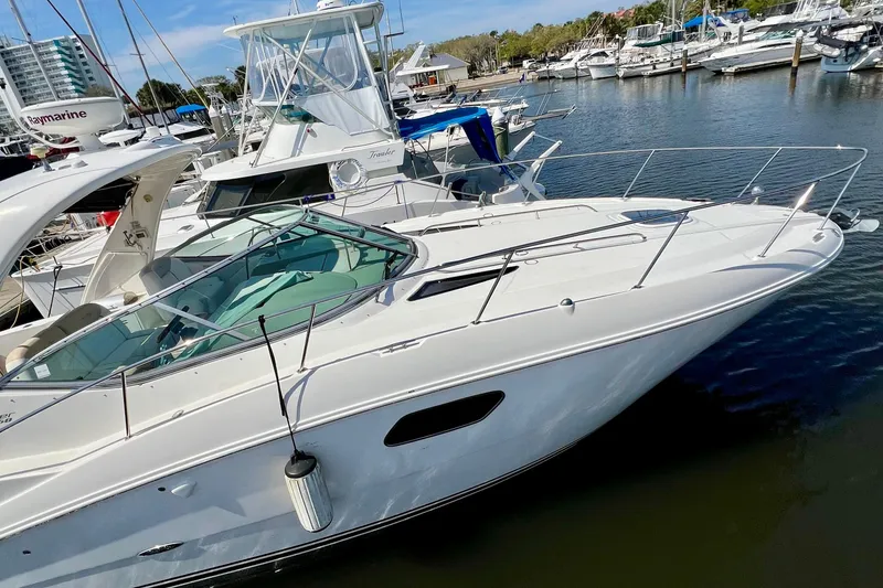 Slide: The Image of 2010 Sea Ray 350 Sundancer yacht docked in a marina, surrounded by other boats. - 8