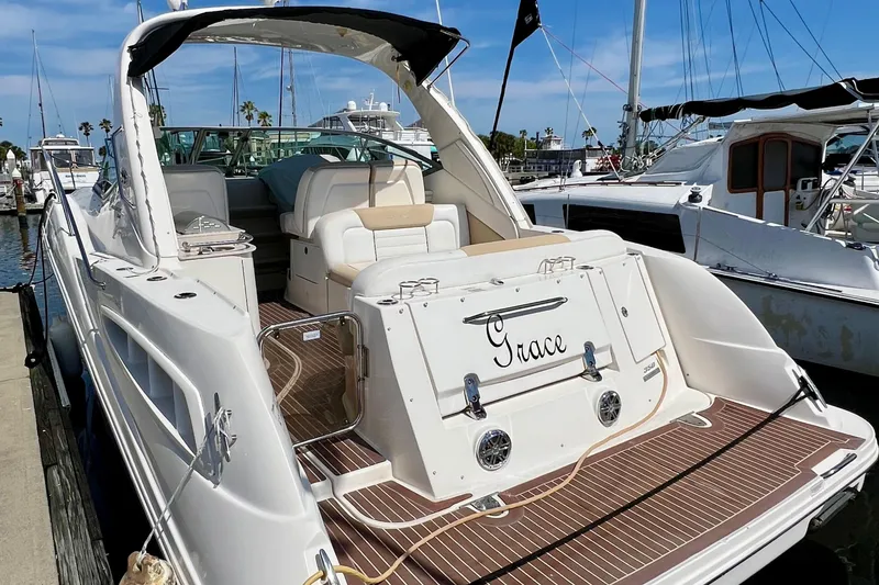Slide: The Image of 2010 Sea Ray 350 Sundancer yacht docked, featuring spacious deck and elegant design. - 9