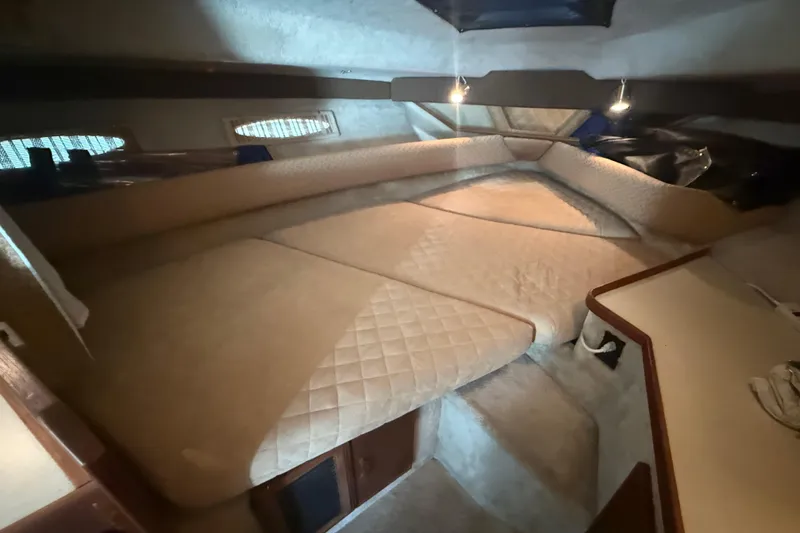 Slide: The Image of Interior cabin of 1986 Sea Ray 300 Weekender with beige quilted bedding. - 19