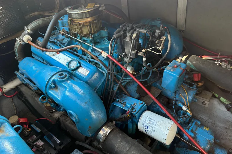 Slide: The Image of Engine compartment of a 1986 Sea Ray 300 Weekender boat, featuring a blue marine engine. - 26