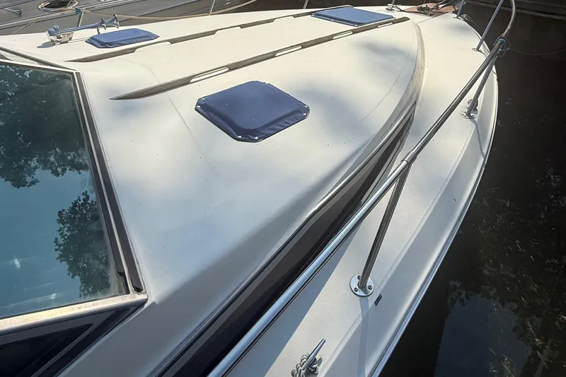 Slide: The Image of 1986 Sea Ray 300 Weekender boat deck with railing and hatches. - 5