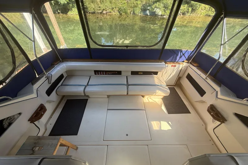 Slide: The Image of 1986 Sea Ray 300 Weekender interior with seating, windows, and water view. - 8