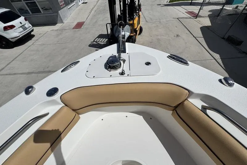 Slide: The Image of 2016 NauticStar 25 XS boat bow with tan seating and anchor setup. - 12