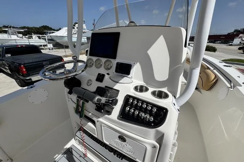 Slide: The Image of 2016 NauticStar 25 XS boat console with steering wheel, gauges, and control panel. - 22