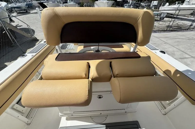 Slide: The Image of 2016 NauticStar 25 XS boat seating with tan and brown upholstery. - 25