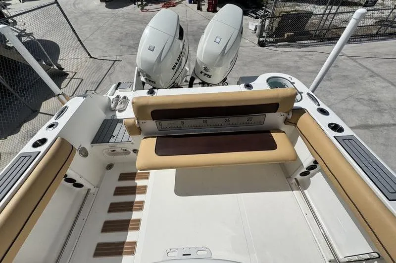 Slide: The Image of 2016 NauticStar 25 XS boat with dual outboard engines and cushioned seating. - 26