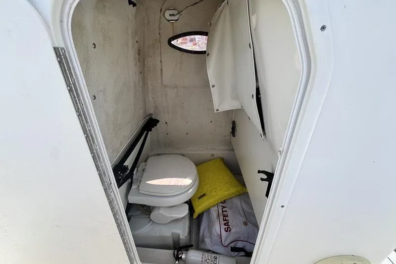 Slide: The Image of Interior of 2016 NauticStar 25 XS boat with toilet and safety equipment. - 31