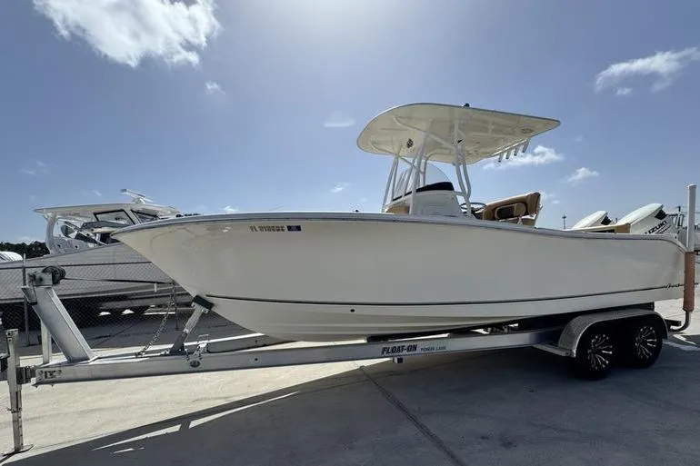 Slide: The Image of 2016 NauticStar 25 XS boat on trailer under clear blue sky. - 5