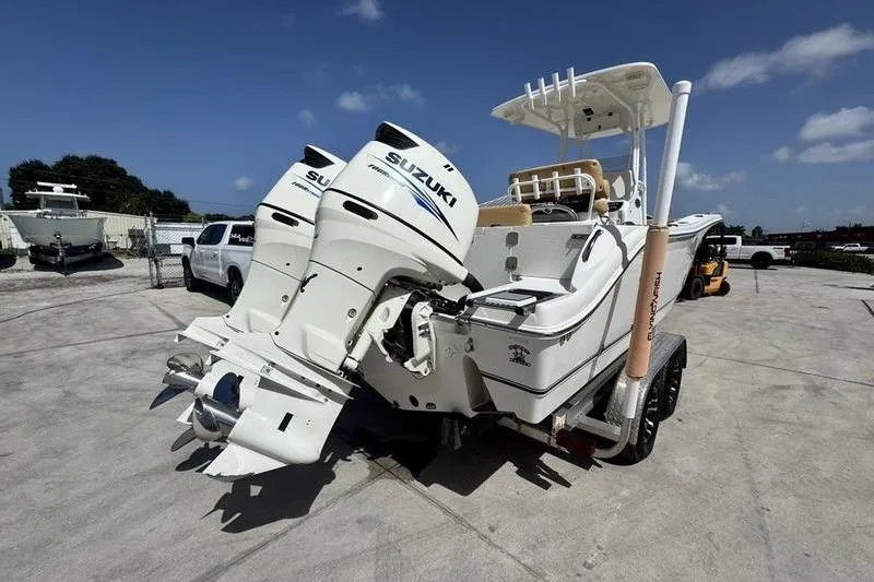 Slide: The Image of 2016 NauticStar 25 XS boat with dual Suzuki outboard motors on a trailer. - 7