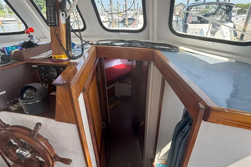 Slide: The Image of Interior view of 1985 Rosborough RF-35 Atlantic Trawler, featuring helm and cabin entrance. - 11