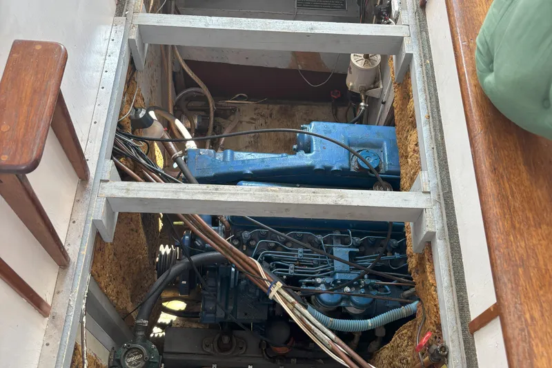 Slide: The Image of Engine compartment of 1985 Rosborough RF-35 Atlantic Trawler, showcasing blue machinery and wiring. - 12