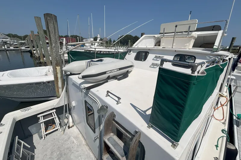 Slide: The Image of 1985 Rosborough RF-35 Atlantic Trawler docked, featuring green canvas and a Mercury inflatable boat. - 14
