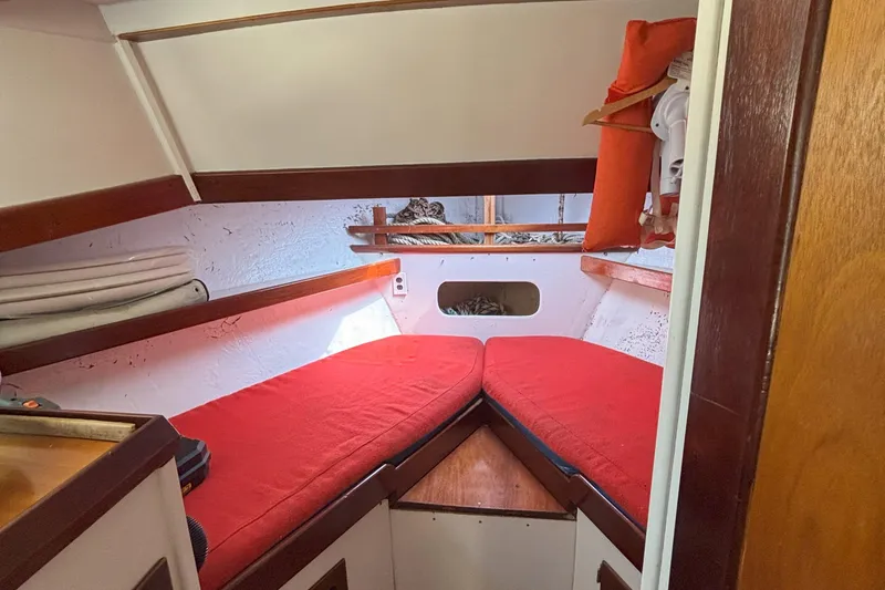 Slide: The Image of Cozy cabin interior of 1985 Rosborough RF-35 Atlantic Trawler with red cushions and wooden accents. - 17