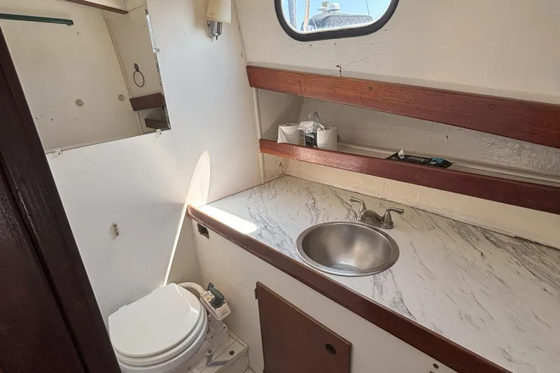 Slide: The Image of 1985 Rosborough RF-35 Atlantic Trawler bathroom with sink, toilet, and marble countertop. - 18