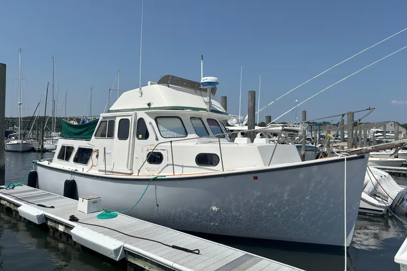 Slide: The Image of 1985 Rosborough RF-35 Atlantic Trawler docked at marina under clear blue sky. - 4
