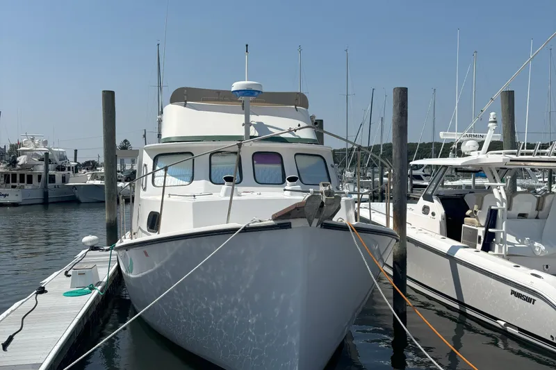 Slide: The Image of 1985 Rosborough RF-35 Atlantic Trawler docked at marina, surrounded by other boats. - 5
