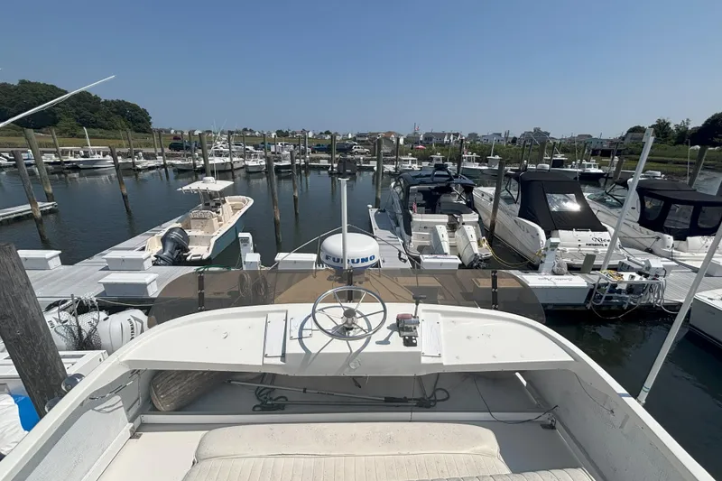 Slide: The Image of 1985 Rosborough RF-35 Atlantic Trawler docked in a marina, surrounded by various boats. - 6