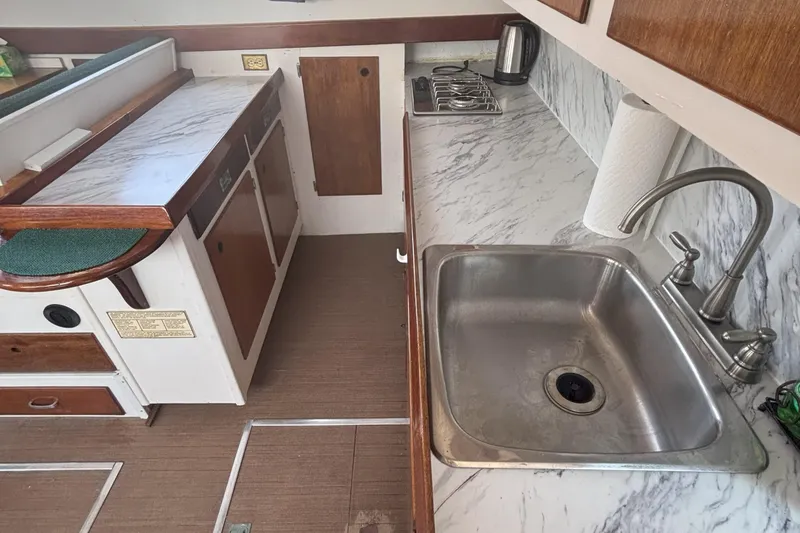 Slide: The Image of 1985 Rosborough RF-35 Atlantic Trawler kitchen with sink, stove, and marble countertops. - 7
