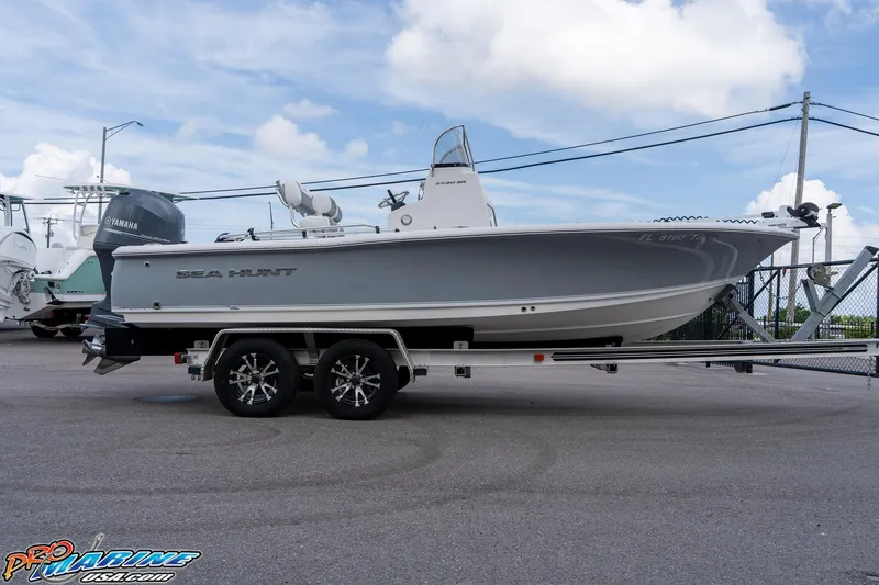Slide: The Image of 2015 Sea Hunt BX 20 BR boat on trailer, parked outdoors under a clear sky. - 11