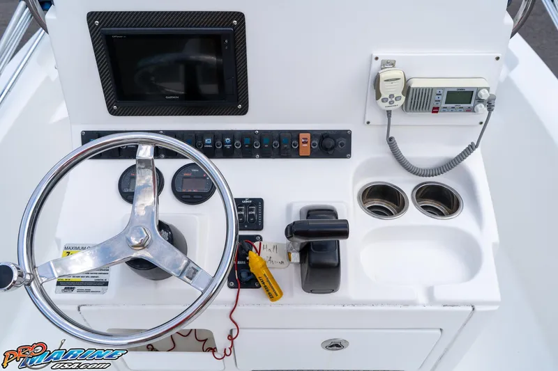 Slide: The Image of 2015 Sea Hunt BX 20 BR boat console with steering wheel, gauges, and communication equipment. - 21