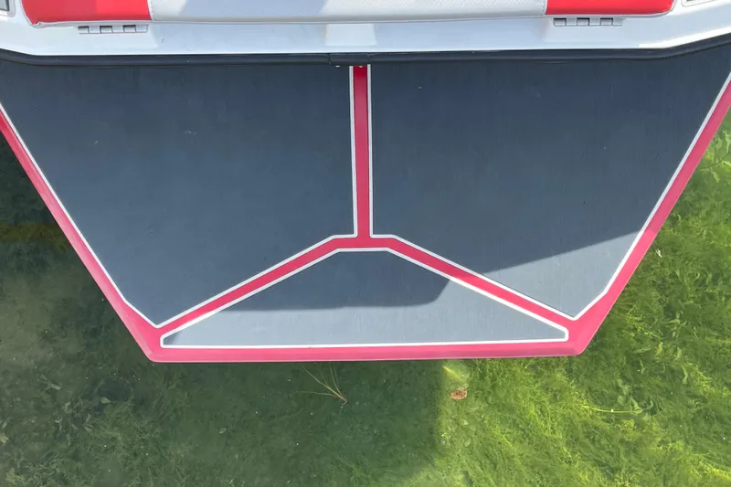 Slide: The Image of 2017 Heyday WT-1 boat deck with red and gray design, floating on clear water. - 10