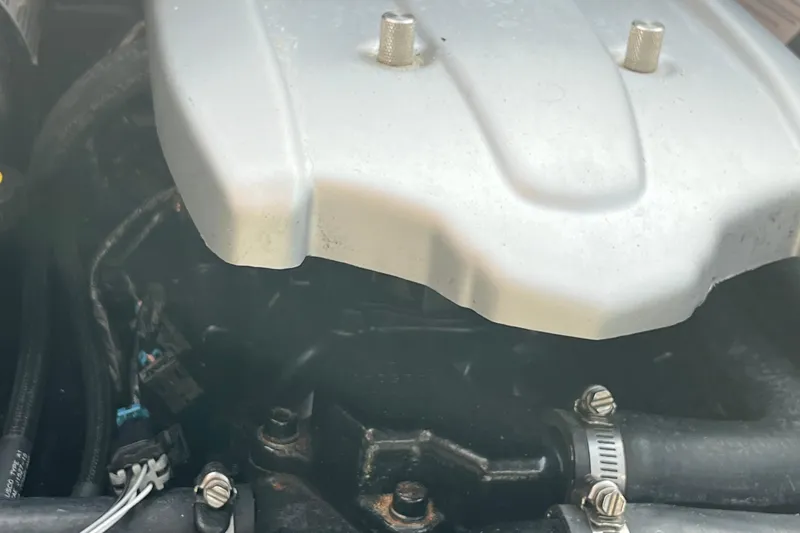 Slide: The Image of Engine compartment of a 2017 Heyday WT-1 boat, showing metal cover and hoses. - 12