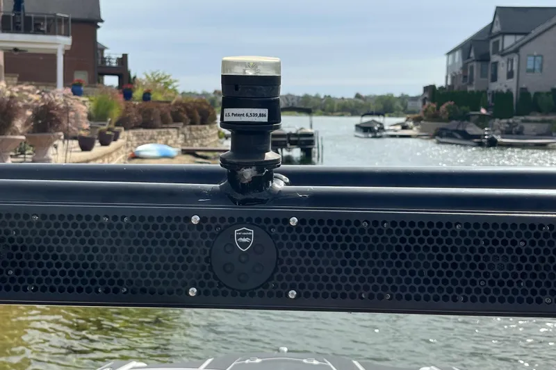 Slide: The Image of 2017 Heyday WT-1 boat with speaker and patent label, docked in a scenic waterfront area. - 9