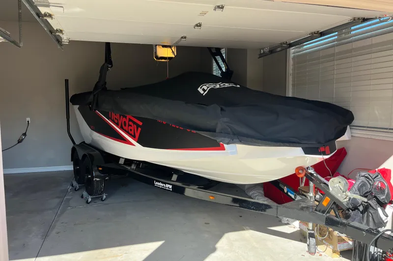 Slide: The Image of 2017 Heyday WT-1 boat covered in a garage, on a trailer. - 14