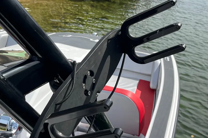 Slide: The Image of 2017 Heyday WT-1 boat with wakeboard rack, red and white seating, on water. - 7
