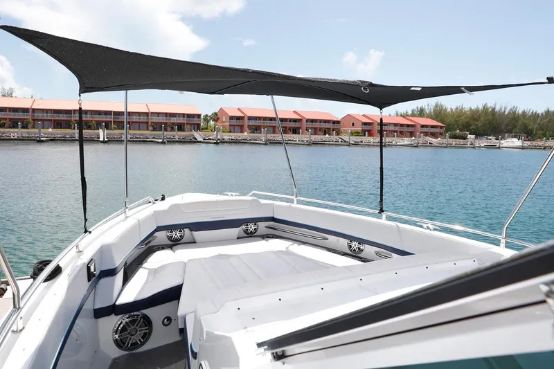 Slide: The Image of Manufacturer Provided Image: 2026 Formula 380 Super Sport Crossover OB boat with sunshade, docked near waterfront buildings. - 8