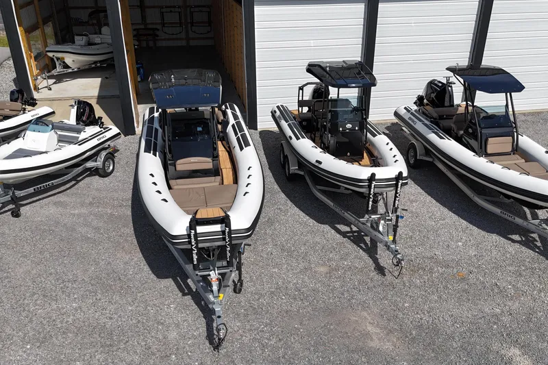 The Image of 2026 Brig Eagle 6.7 boats on trailers, parked outside a garage. - 0