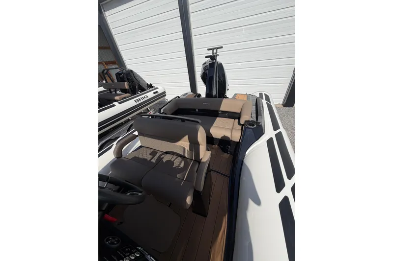 Slide: The Image of 2026 Brig Eagle 6.7 boat interior with tan seating and modern design. - 10