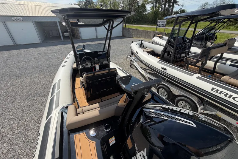 Slide: The Image of 2026 Brig Eagle 6.7 boat with sleek design, parked outdoors on gravel. - 4