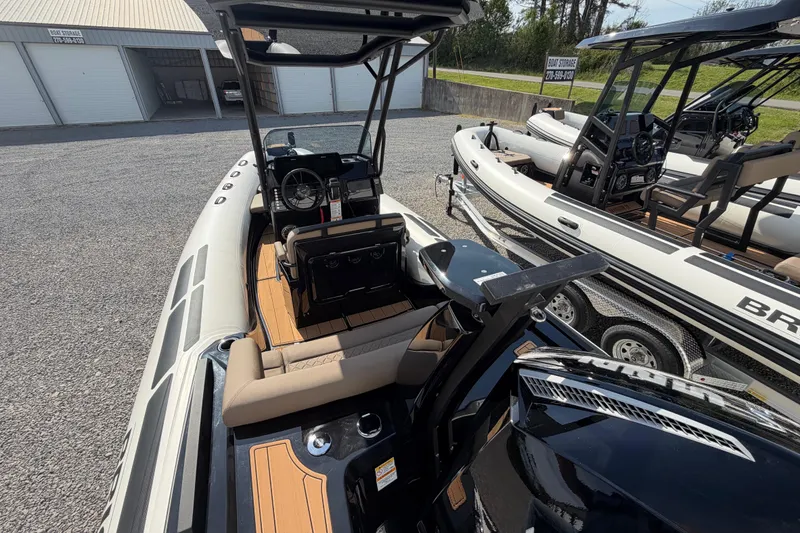 Slide: The Image of 2026 Brig Eagle 6.7 boat with sleek interior and modern design, parked outdoors. - 5