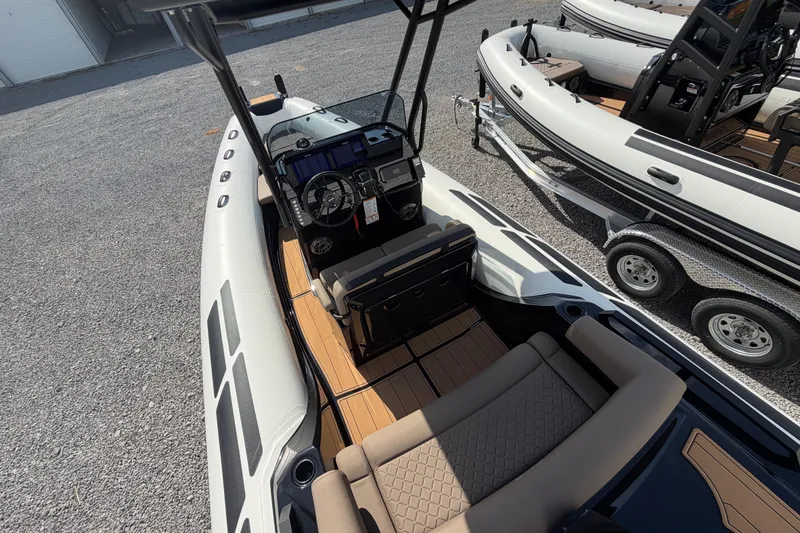 Slide: The Image of 2026 Brig Eagle 6.7 boat interior with modern dashboard and seating. - 6