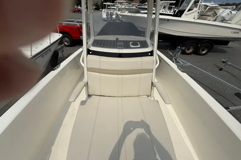Slide: The Image of 2024 Boston Whaler 220 Dauntless boat interior with seating and console view. - 3
