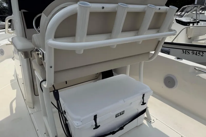 Slide: The Image of 2024 Boston Whaler 220 Dauntless boat interior with rod holders and Yeti cooler. - 7