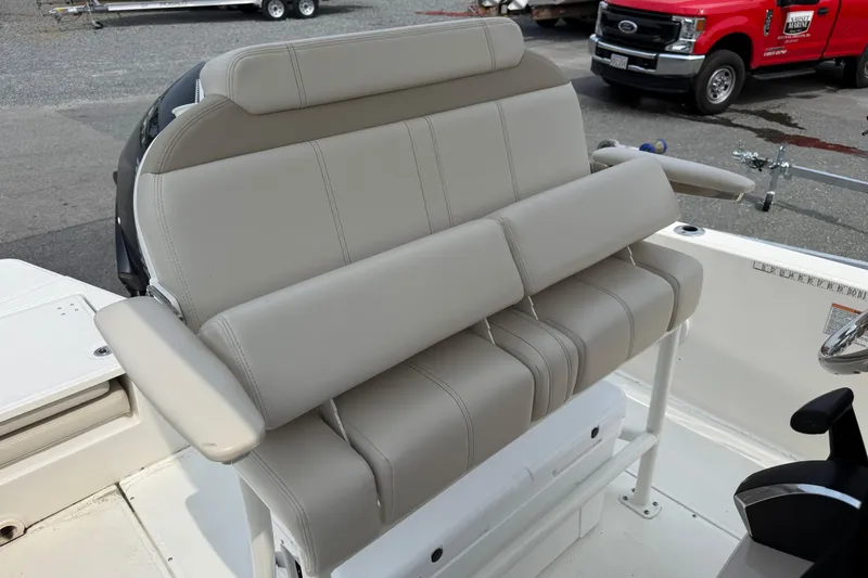 Slide: The Image of 2024 Boston Whaler 220 Dauntless boat seating with beige upholstery and armrests. - 8