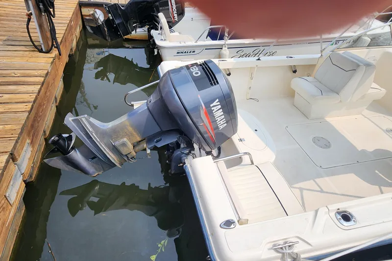 Slide: The Image of 2001 Sea Hunt 19 Dual Console boat with Yamaha outboard motor docked at marina. - 14