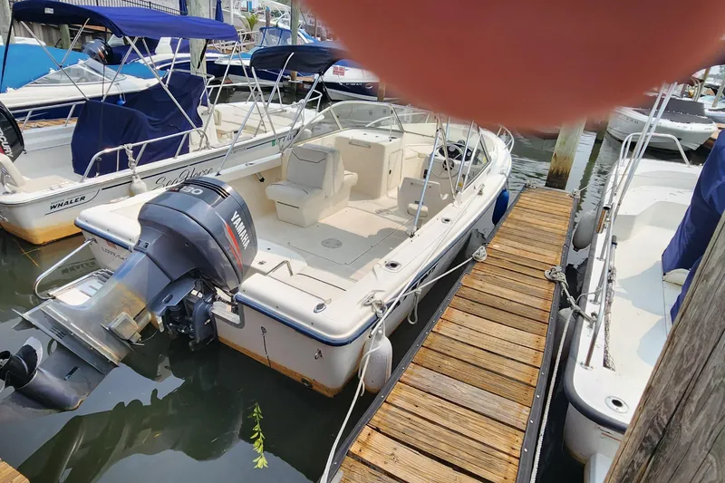 Slide: The Image of 2001 Sea Hunt 19 Dual Console boat docked with Yamaha outboard motor. - 15