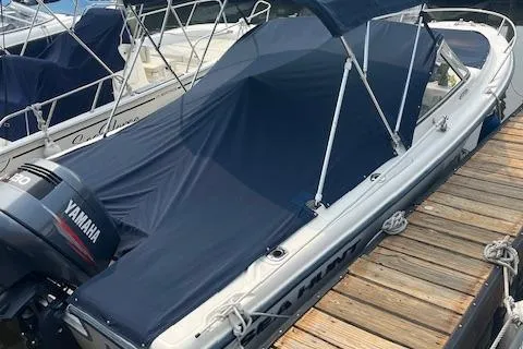 Slide: The Image of 2001 Sea Hunt 19 Dual Console boat with Yamaha engine, docked and covered. - 3