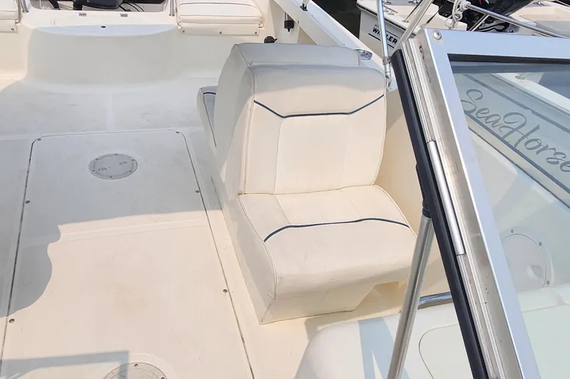 Slide: The Image of 2001 Sea Hunt 19 Dual Console boat interior with white seating and deck. - 7