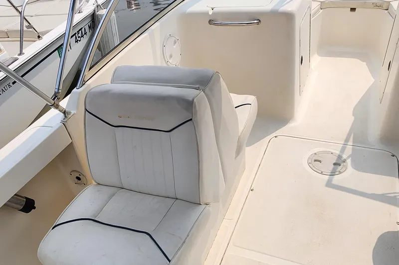 Slide: The Image of 2001 Sea Hunt 19 Dual Console boat interior with white seating and clean deck. - 8