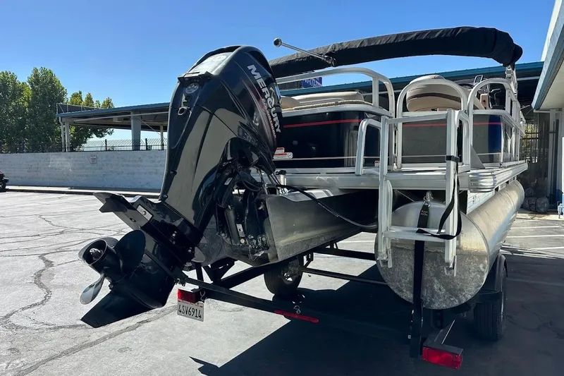 Slide: The Image of 2019 Sun Tracker Bass Buggy 18 DLX pontoon boat with Mercury outboard motor on trailer. - 10