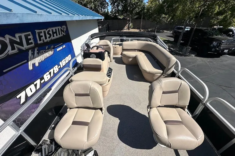 Slide: The Image of 2019 Sun Tracker Bass Buggy 18 DLX pontoon boat with beige seating and spacious deck. - 11