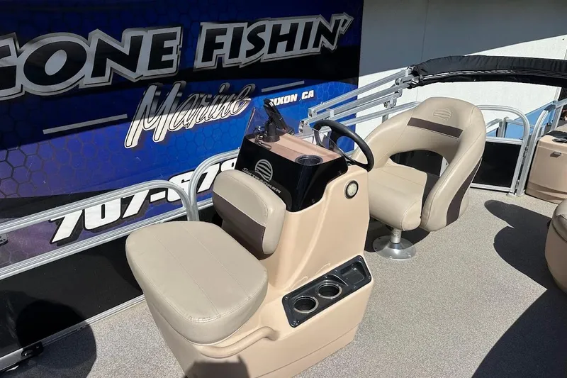 Slide: The Image of 2019 Sun Tracker Bass Buggy 18 DLX boat interior with beige seating and steering console. - 14