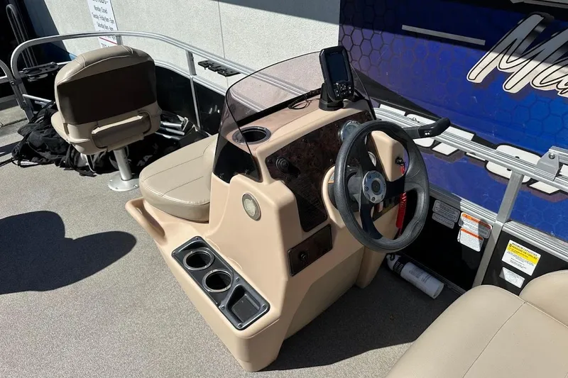 Slide: The Image of 2019 Sun Tracker Bass Buggy 18 DLX boat interior with steering console and seating. - 20